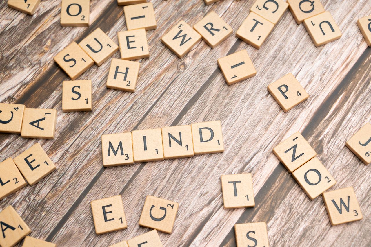 Scattered wooden letter tiles on a rustic wood surface highlighting the word 'Mind'. Ideal for mental and cognitive themes.