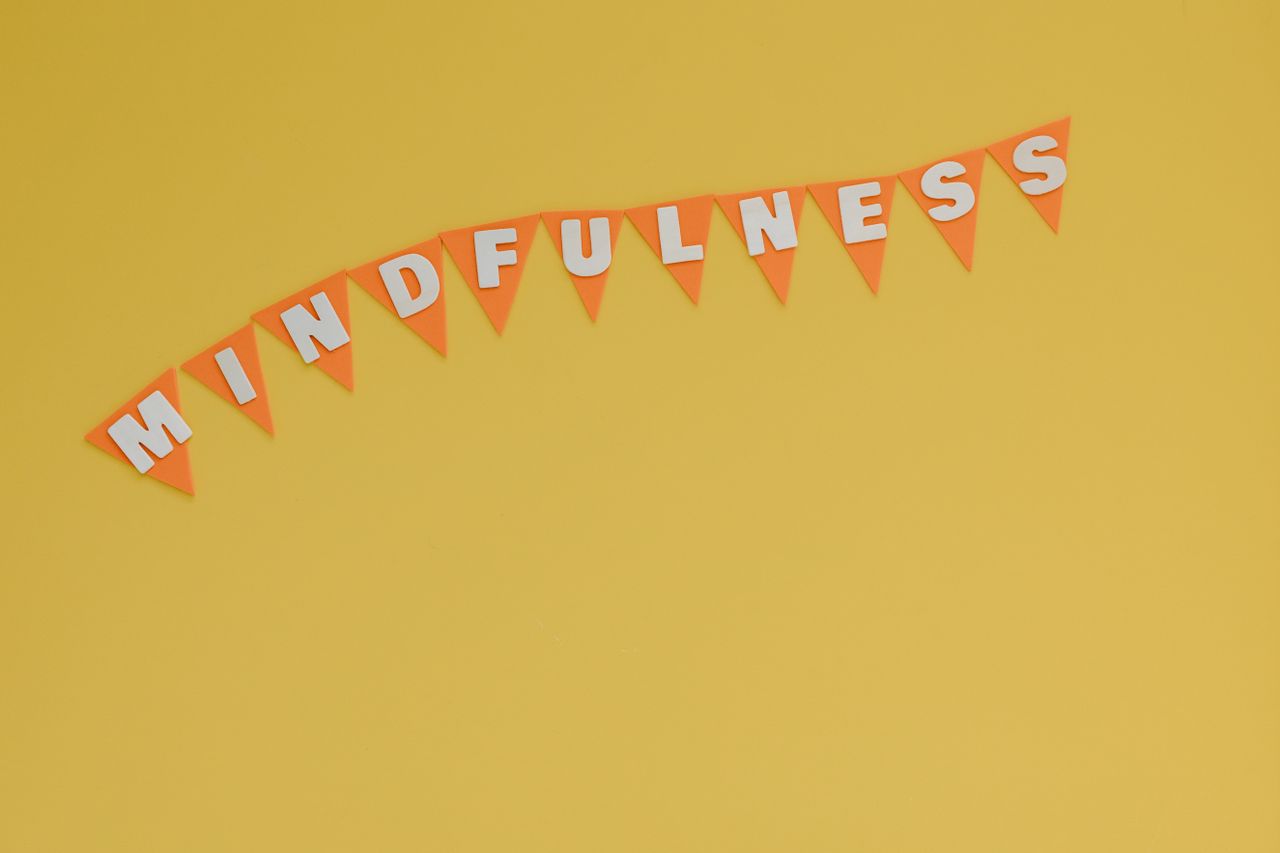 Banner with 'Mindfulness' on a bright yellow background, symbolizing calm and focus.